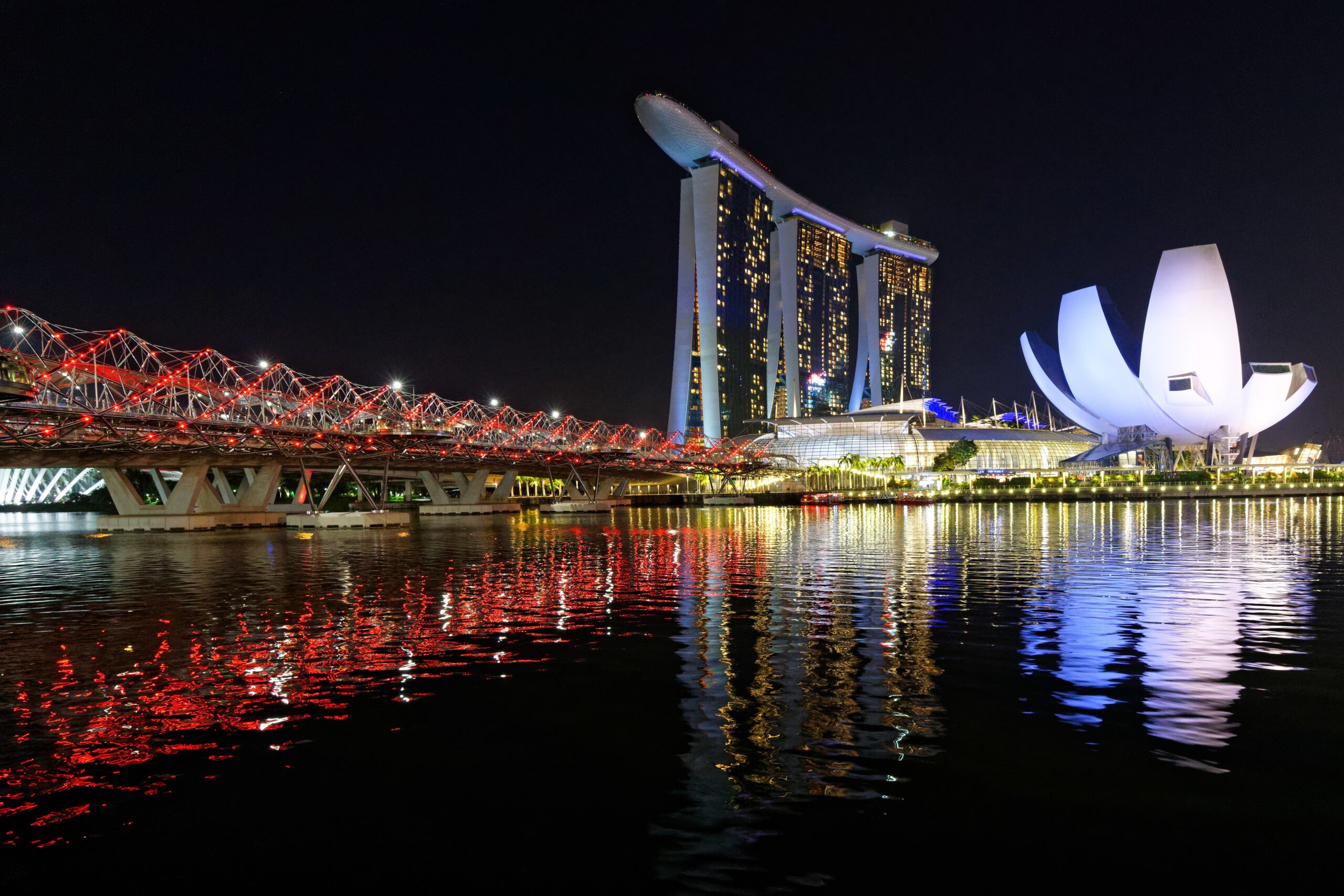 A beautiful shot of the tall architectural buildings of Singapore Marina Bay Sands and Helix Bridge